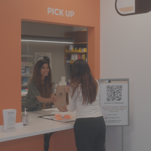 Pharmacist handing medication to patient