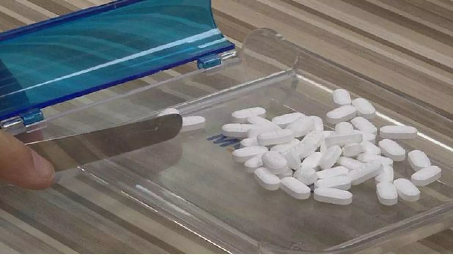Pharmacist counting medication tablets